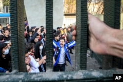 FILE - In this Dec. 30, 2017 file photo, taken by an individual not employed by the Associated Press and obtained by the AP outside Iran, university students attend an anti-government protest inside Tehran University, in Tehran, Iran.