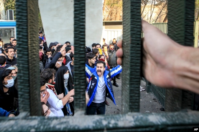 FILE - In this Dec. 30, 2017 file photo, taken by an individual not employed by the Associated Press and obtained by the AP outside Iran, university students attend an anti-government protest inside Tehran University, in Tehran, Iran.