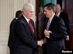 Vice President Mike Pence greets National Security Advisor Michael Flynn before Japanese Prime Minister Shinzo Abe and U.S. President Donald Trump arrive for their joint news conference at the White House in Washington, Feb. 10, 2017.