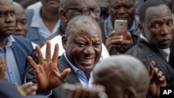 President Cyril Ramaphosa greets supporters after casting his vote at the Hitekani Primary School in Soweto, Johannesburg, South Africa, May 8, 2019. His ruling African National Congress is set to win and retain power for the sixth time in a row.