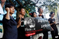 Supporters of Taiwanese activist Lee Ming-che detained in China, chant their support during a media event in Taipei, Taiwan, Nov. 28, 2017.