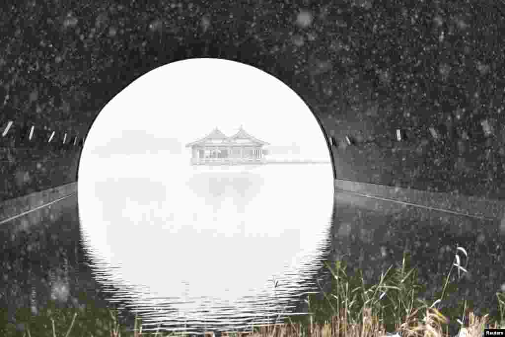 Pavilions are seen on a lake during a snow day in Xi'an, Shaanxi province, China, Nov. 22, 2016.