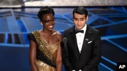 Lupita Nyong'o, left, and Kumail Nanjiani present the award for best production design at the Oscars, March 4, 2018.