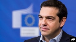 FILE - Greece's Prime Minister Alexis Tsipras addresses the media at the European Commission headquarters in Brussels, March 13, 2015. 