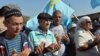 FILE - Crimean Tatars pray as they block the road at the checkpoint between Ukraine and Crimea, in Chongar, September 20, 2015. Hundreds of representatives of the Muslim Crimean Tatar community took part in a blockade from Ukraine to the Crimean peninsula annexed by Russia in March 2014, to protest against the violation of their rights. 