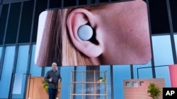 Rick Osterloh, Senior Vice President of Devices and Services at Google, speaks about Pixel Buds (displayed on screen) as this and other products were announced Tuesday, Oct. 15, 2019, in New York. (AP Photo/Craig Ruttle)