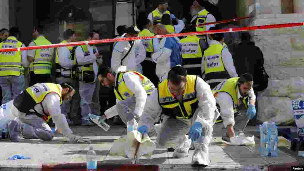 Members of the Israeli Zaka emergency response team clean blood from the scene of an attack at a Jerusalem synagogue, Nov. 18, 2014. 