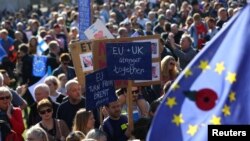 Protesters participating in an anti-Brexit demonstration march through central London, Britain, Oct. 20, 2018.