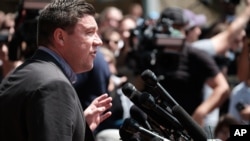 FILE - Unite The Right rally organizer Jason Kessler attempts to speak at a press conference in front of Charlottesville City Hall in Charlottesville, Virginia, Aug. 13, 2017. 