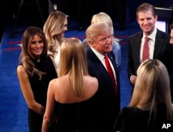 Donald Trump talks to his family after debate.