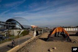 Homeless tents are pitched on the Santa Ana River trail near the Anaheim Regional Transportation Intermodal Center, a $185-million transportation center, in Anaheim, California, Dec. 2, 2017.