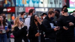 Employees of Coinbase Global Inc, the biggest U.S. cryptocurrency exchange, watch as their listing is displayed on the Nasdaq MarketSite jumbotron at Times Square in New York, U.S., April 14, 2021. REUTERS/Shannon Stapleton