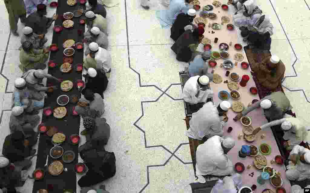 People break their fast during the Muslim holy fasting month of Ramadan, at a mosque in Peshawar, Pakistan.