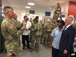 FILE - Lt. Gen. Stephen Townsend takes a photo of Defense Secretary Jim Mattis and a dining facility worker at Fort Bragg, N.C., Dec. 22, 2017.