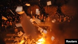 Ukrainian protesters throw out and burn papers from prosecutor's headquarters in Lviv, western Ukraine, Feb. 19, 2014. 