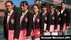 Chinese students prepare for the opening ceremony of the Haileybury College's in Tianjin. Chinese companies operate international programs throughout the country to prepare student for study abroad.