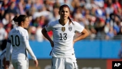 United States' Carli Lloyd (10) and Alex Morgan (13) wait for play to continue during an Olympic qualifying tournament soccer match against Mexico, Feb. 13, 2016, in Frisco, Texas. 