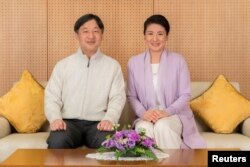 Japan's Crown Prince Naruhito, left, and Crown Princess Masako pose for a photo at their residence Togu Palace in Tokyo, Feb. 17, 2019.