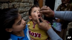 FILE - A Pakistani health worker gives a polio vaccine to a child in Islamabad, Dec. 8, 2014. (AP Photo/B.K. Bangash)