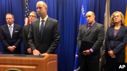 U.S. Attorney John Anderson, center at podium, speaks about the investigation into a fugitive Catholic priest who is accused of sex abuse at a news conference, Sept. 21, 2018, in Albuquerque, N.M. Federal authorities said FBI agents returned 80-year-old Arthur Perrault to New Mexico on Friday to face child sexual abuse charges after a year in the custody of Moroccan authorities.