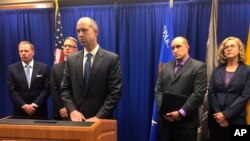 U.S. Attorney John Anderson, center at podium, speaks about the investigation into a former New Mexico priest who is accused of sex abuse, at a news conference in Albuquerque, N.M., Sept. 21, 2018. A federal judge decided Tuesday that Arthur Perrault will remain in prison to await trial on the charges.
