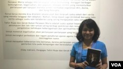 Penulis Feby Indirani memegang buku karyanya "Bukan Perawan Maria" di lokasi pameran di Bandung Creative Hub, Minggu (9/9) (Foto: VOA/Rio).