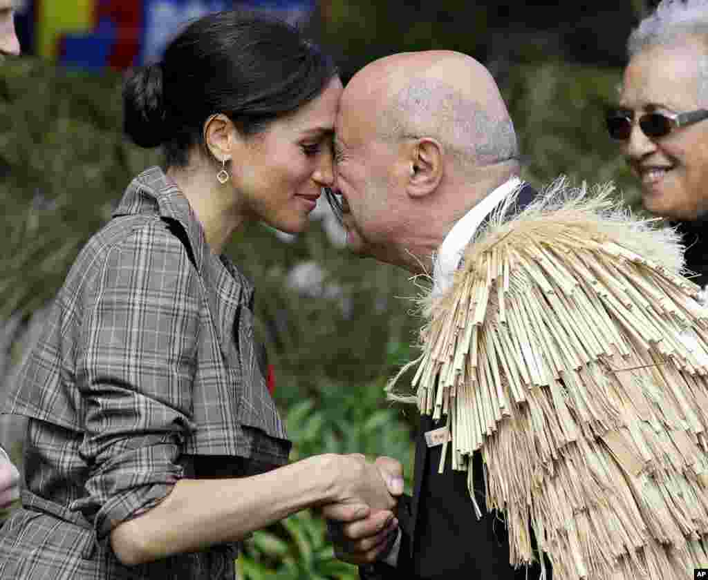 Meghan, Duchess of Sussex receives a &quot;hongi&quot; a traditional Maori welcome on the lawns of Government House in Wellington, New Zealand.