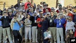 Phil Mickelson hits out of the rough on the ninth hole during a practice round for the Masters golf tournament, in Augusta, Georgia, April 6, 2011