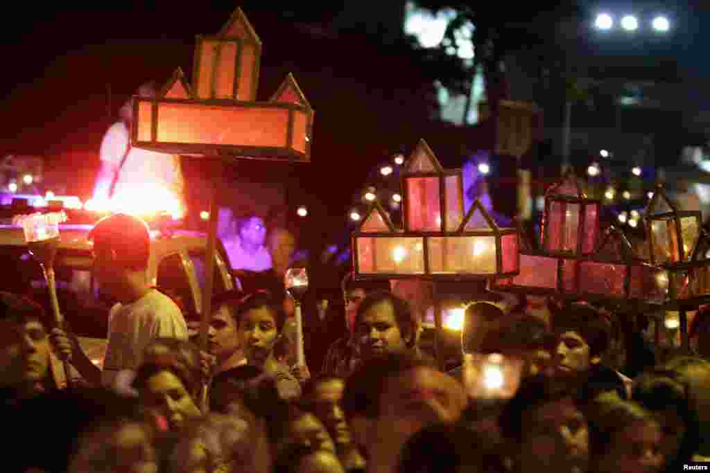 Catholics hold candles during the Way of the Cross re-enactment in a Holy Week procession, Luque, Paraguay, March 27, 2013. 