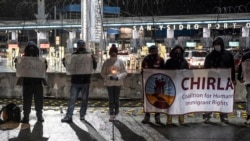 Advocates and migrants demonstrate at the San Ysidro crossing port during a vigil call “Path towards Humane Immigration Reform”, in Tijuana, Baja California state, Mexico on January 19, 2021. - As President elect Joseph Bide prepares for his inauguration,