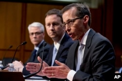 FILE - Google's Law Enforcement and Information Security Director Richard Salgado, right, accompanied by Twitter's Acting General Counsel Sean Edgett, center, and Facebook's General Counsel Colin Stretch, left, speaks during a Senate Committee on the Judiciary, Subcommittee on Crime and Terrorism hearing on Capitol Hill in Washington, Oct. 31, 2017.
