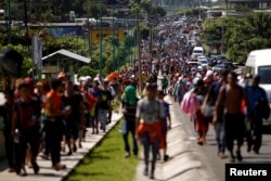 Central American migrants walk along the highway near the border with Guatemala, as they continue their journey trying to reach the U.S., in Tapachula, Mexico, Oct. 21, 2018.