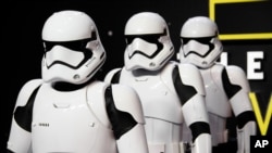 FILE - Actors dressed as Stormtroopers pose for photographers upon arrival at the European premiere of the film 'Star Wars: The Force Awakens ' in London, Dec. 16, 2015.
