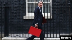 FILE - Britain's Chancellor of the Exchequer Phillip Hammond arrives in Downing Street in London, Britain, Sept. 7, 2016.