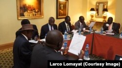 Negotiators at South Sudan peace talks in Addis Ababa review a draft cessation of hostilities agreement on Jan. 13, 2014.