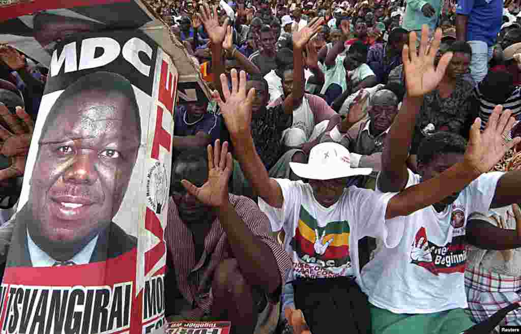 Supporters of the opposition Movement For Democratic Change (MDC) raise their hands as they cheer their leader Morgan Tsvangirai during a rally in Harare January 20, 2008.