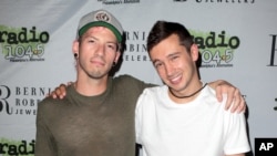 Josh Dun, left, and Tyler Joseph of the band Twenty One Pilots pose for photographers backstage during the Radio 104.5 9th Birthday Show at BB&T Pavilion, June 11, 2016, in Camden, N.J.