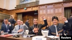 Bolivian President Evo Morales (R) gestures as he arrives for the opening of hearings at the World Court in The Hague, Netherlands, March 19, 2018. 