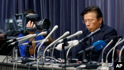 Mitsubishi Motors Corp. President Tetsuro Aikawa listens to a reporter's question during a press conference in Tokyo, Wednesday, May 18, 2016. Aikawa said Wednesday that he will step down to take responsibility for the mileage cheating scandal unfolding a