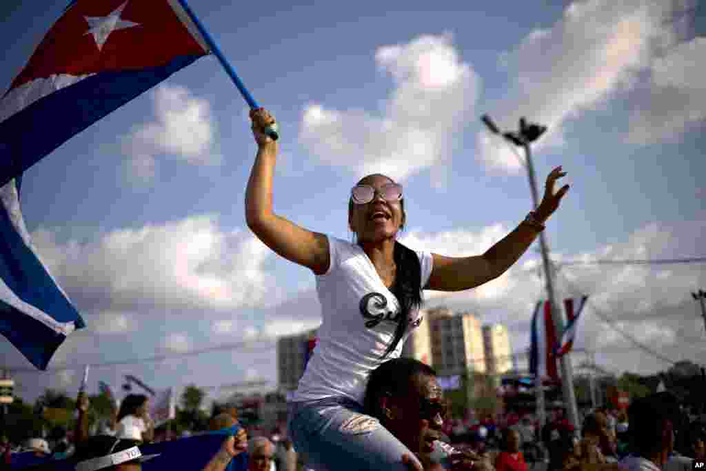 A woman waving a national flag march during the traditional May Day parade at Revolution Square in Havana, Cuba, May 1, 2018.