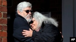 Susan Bro, mother of Heather Heyer, hugs her husband, Kent in front of Charlottesville Circuit Court after a jury recommended life plus 419 years for James Alex Fields Jr. for the death of Heyer as well as several oth