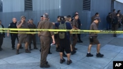 UPS workers are seen gathered outside after a reported shooting at a UPS warehouse and customer service center in San Francisco, California, June 14, 2017.
