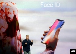 In this Tuesday, Sept. 12, 2017, file photo, Phil Schiller, Apple's senior vice president of worldwide marketing, announces features of the new iPhone X, including Face ID, at the new Apple campus in Cupertino, Calif. (AP Photo/Marcio Jose Sanchez, File)