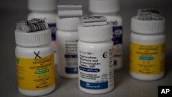 FILE - Bottles of several opioid-based medication at a pharmacy in Portsmouth, Ohio.