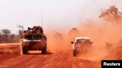 FILE - Troops drive to Segou, Jan. 16, 2013. Gunmen ambushed a convoy Tuesday, killing four soldiers.