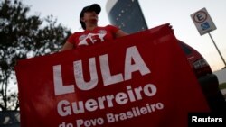 Supporters of Brazil's Former President Luiz Inacio Lula da Silva, display banners with text written in Portuguese that read "Free Lula" during a protest in front of the Superior Electoral Court, in Brasilia, Brazil, Aug. 31, 2018. 
