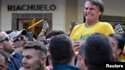 Brazilian presidential candidate Jair Bolsonaro reacts after being stabbed during a rally in Juiz de Fora, Minas Gerais state, Brazil, Sept. 6, 2018. 