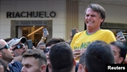 FILE - Brazilian presidential candidate Jair Bolsonaro reacts after being stabbed during a rally in Juiz de Fora, Minas Gerais state, Brazil, Sept. 6, 2018.