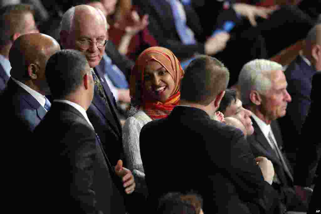Rep.-elect Ilhan Omar, D-Minn., talks on the House floor before being sworn in at the Capitol in Washington, Jan. 3, 2019. 