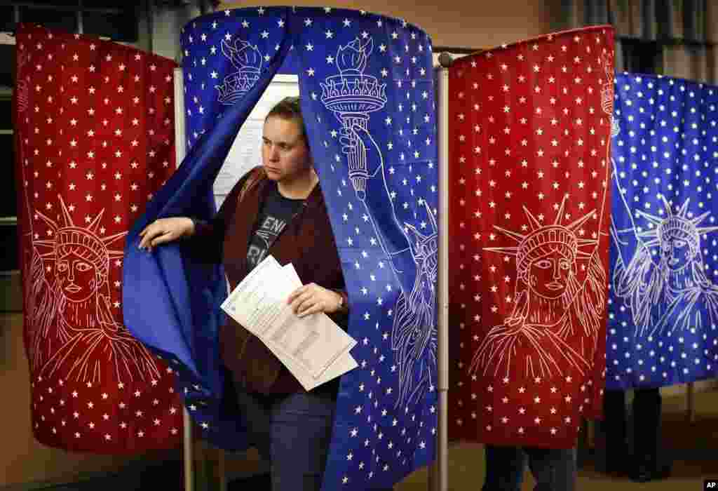 Susan Dauchand exits a voting booth after making her selections in the mid-term election, Nov. 6, 2018, in Mechanic Falls, Maine.